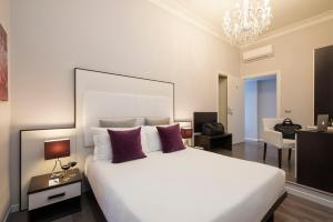 Postel nebo postele na pokoji v ubytování Arenula Suites