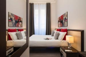 Postel nebo postele na pokoji v ubytování Arenula Suites