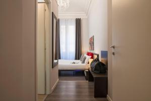 Postel nebo postele na pokoji v ubytování Arenula Suites