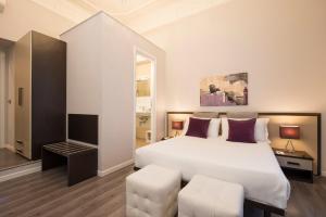 Postel nebo postele na pokoji v ubytování Arenula Suites