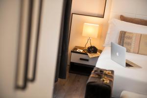Postel nebo postele na pokoji v ubytování Arenula Suites