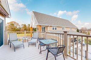 a deck with chairs and a table and a house at Rehoboth Beach --- 35526 Dry Brook Dr in Rehoboth Beach