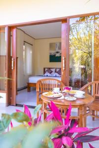 pokój ze stołem i krzesłami oraz sypialnia w obiekcie Chandra House Ubud w mieście Ubud