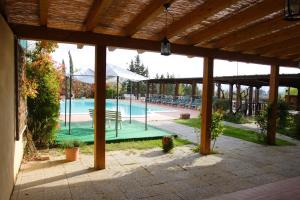 a large outdoor pool with a pavilion and a swimming pool at Agriturismo Cameli in Certaldo