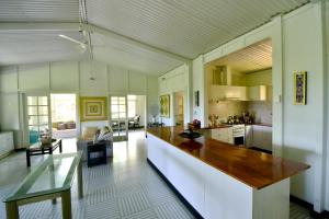 a large kitchen with a large island in the middle at Cow Bay Hilltop Escape in Cow Bay