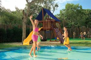 two children playing in the water at a playground at Dreams Tulum Resort & Spa in Tulum