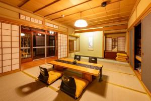 a room with a table and some chairs in it at villa the rise hakodate in Hakodate