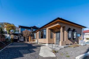 a small brick house with a driveway at villa the rise hakodate in Hakodate