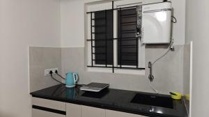 a kitchen with a counter top with amosphericermottermott at 3 Home Tales (Brookefield) in Bengaluru +45 photos