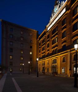 a building with a clock tower on top of it at Molino Stucky Flat in Venice