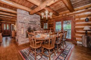a dining room with a table and chairs at Massive Rustic Waterfront Log Cabin in Stokes Bay