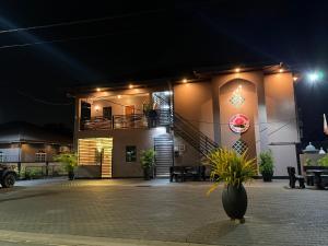 a building with a staircase on the side of it at night at Tulip Rosé appartments in Paramaribo