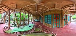 a painting of a house with a table in it at Jui Chi MaMa Ecolodge & Birding in Palomino