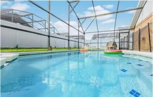 a large swimming pool in a building at Enchanted Disney Vacation Villa in Kissimmee