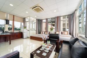 a living room with a couch and a bed at Diamond Luxury Ben Thanh in Ho Chi Minh City