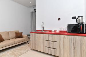 a kitchen with a counter with a microwave and a couch at 4 bedroom Luxury Apartment in Lagos