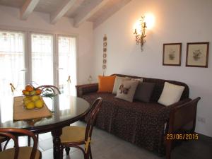 a living room with a couch and a table at Mansarda Lina in Casarza Ligure