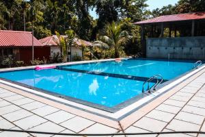 a large swimming pool with blue water at PRISTINE BEACH RESORT in Diglipur