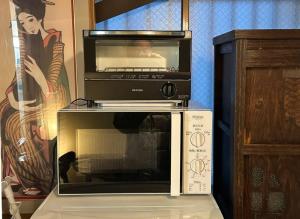 a microwave sitting on top of a toaster oven at Yuririan in Kyoto