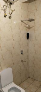 a bathroom with a shower with a toilet at The Gange Hill By Green Bird Hospitality in Rishīkesh
