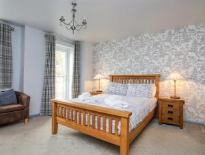 a bedroom with a bed with two towels on it at Vyrnwy Lakeside - Bala Lake in Bala