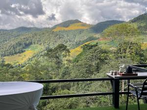 a room with a table and a view of a mountain at The will glamping&camping in Ban Na Pho
