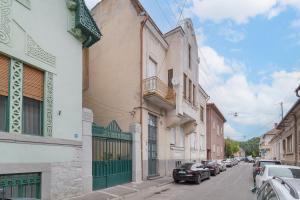 a city street with cars parked on the street at Villa Arta Residence in Oradea