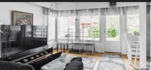 a living room with a couch and a large window at Paukavuori in Seinäjoki