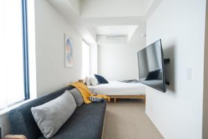 a living room with a couch and a bed at KABIN Gion in Kyoto +34 photos
