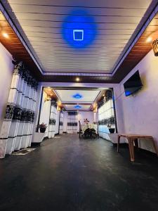 an empty room with a blue light on the ceiling at Newton House in Hiriketiya