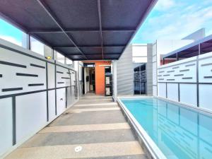 an indoor swimming pool in a building with a house at The Modern A27 Hua-Hin Private Poolvilla from beach 3km in Hua Hin