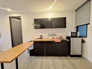 an office with a desk and a refrigerator in a room at The Modern A27 Hua-Hin Private Poolvilla from beach 3km in Hua Hin