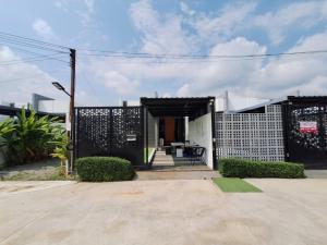 a small house with a black and white exterior at The Modern A27 Hua-Hin Private Poolvilla from beach 3km in Hua Hin
