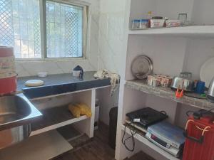 a kitchen with a sink and a counter top at Tirupati home stay in Ujjain