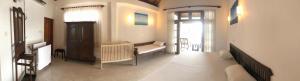 a living room with a bench and a window at Paradise Bay in Beruwala