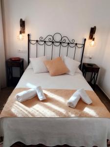 a bedroom with a bed with two towels on it at Hostal Casa Blanca in Seville