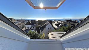 a view of a city from a balcony at Bodenseehotel Renn in Hagnau