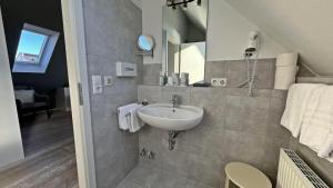 a bathroom with a sink and a mirror at Bodenseehotel Renn in Hagnau +64 photos