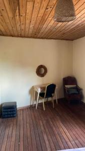 a room with a table and a chair on a wooden floor at Soa Land villa in Antananarivo +29 photos