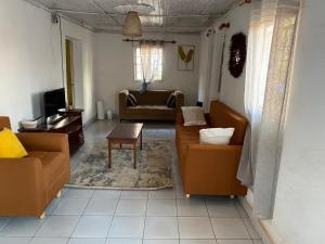 a living room with a couch and a table at Soa Land villa in Antananarivo