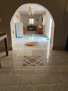 a living room with a tile floor and an archway at Soa Land villa in Antananarivo