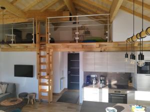 a room with a loft bed in a kitchen at L'escapade du lac in Gérardmer
