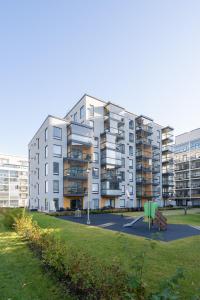 an apartment building with a park in front of it at Modern 1BR Apartment in Kaleva next to Tram Line in Tampere