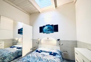 a bedroom with two beds and two pictures on the wall at Loft ANAGNINA in Rome