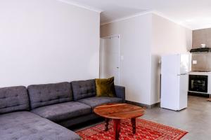a living room with a couch and a table at Emerald Bed&Breakfast in Windhoek