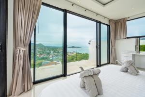 Ένα ή περισσότερα κρεβάτια σε δωμάτιο στο Fisherman Seaview Villas +140 φωτογραφίες