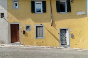 a yellow building with windows and a door at Luca's home over the Rose Garden in Florence