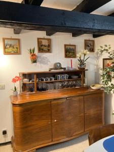 a wooden cabinet in a room with flowers on the wall at Ferienhaus mit Sauna, Wintergarten und Terrasse im schönen Hochtaunus in Glashütten