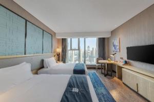 Postel nebo postele na pokoji v ubytování Echarm Hotel Wuhan Hanyang Wangjiawan Sixin Avenue Metro Station