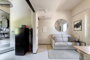 a living room with a refrigerator and a couch at Luca's home over the Rose Garden in Florence